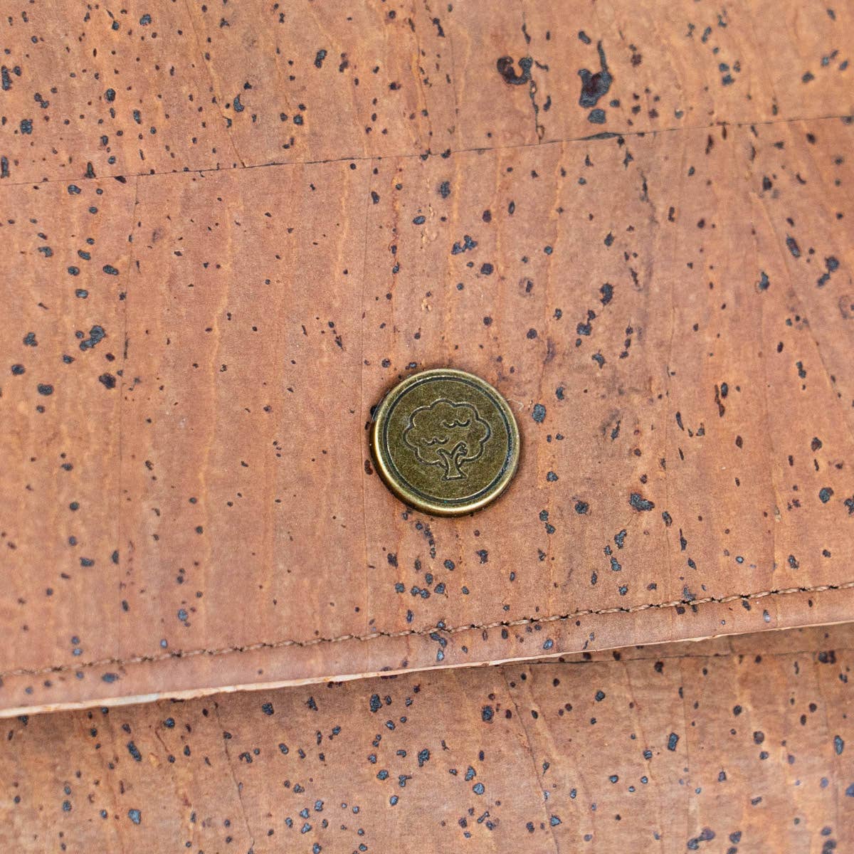 Close-up of cork texture and antique bronze cork tree logo